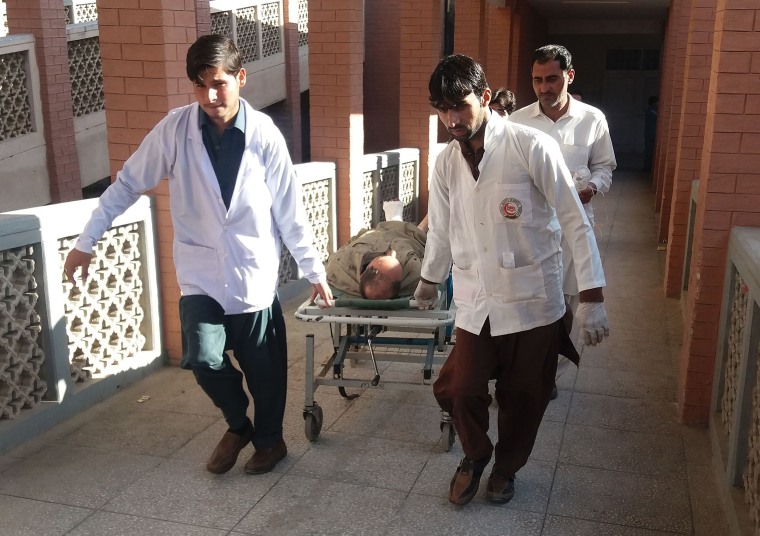 Image: Paramedics transport a victim after Friday's suicide bombing