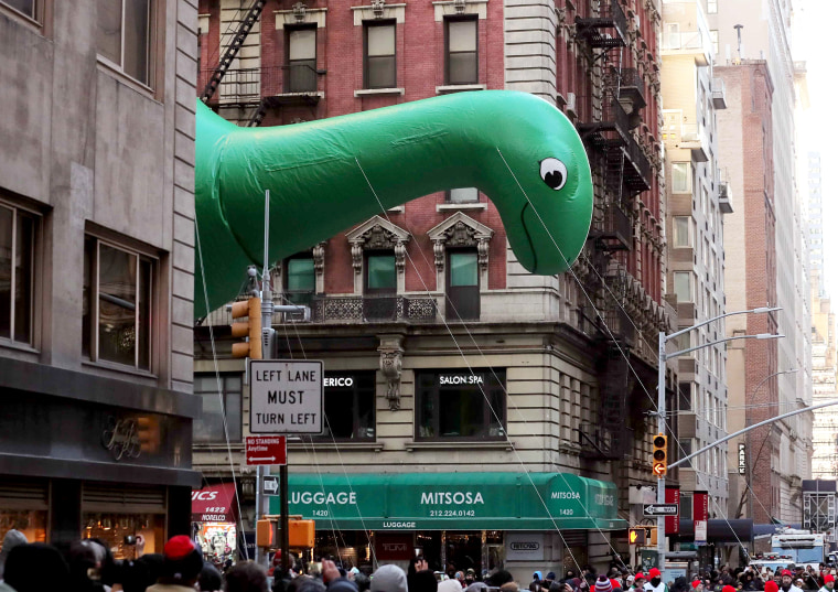 Image: Sinclair's DINO float hovers above the crowd during the Macy's Thanksgiving Day Parade in Manhattan