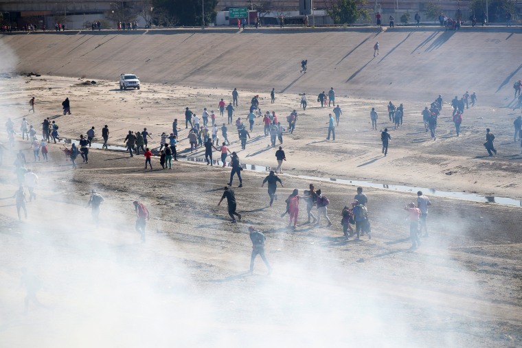 Image: Migrants run from tear gas in Tijuana, Mexico