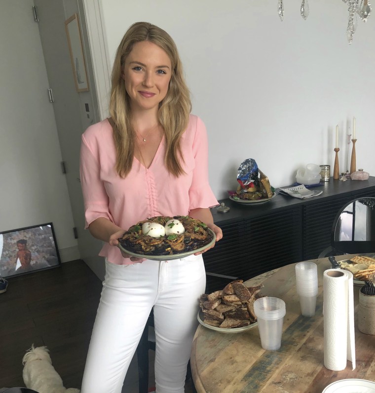 Emily holding plate of food