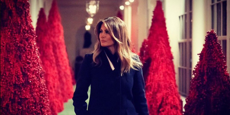 Melania with red Christmas trees