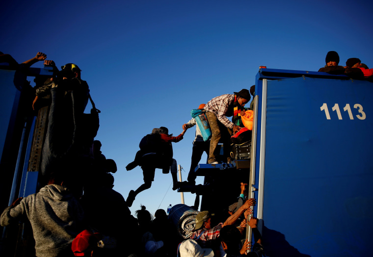 Image: Migrants ride on the back of a truck while making their way to Tijuana from Mexicali, Mexico, on Nov. 20.