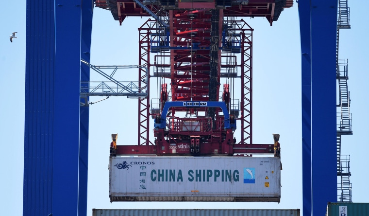 Image: A China Shipping container is loaded at a terminal in the port of Hamburg, Germany