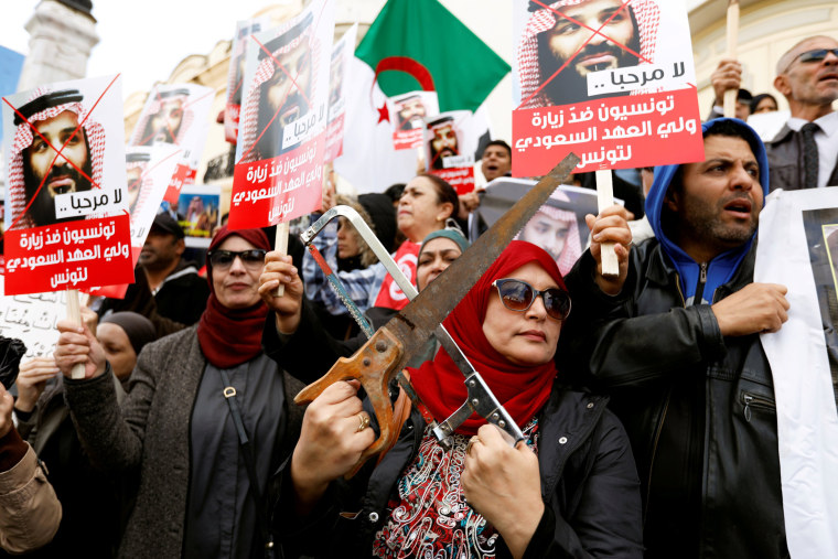 Image: Woman takes part in a protest, opposing the visit of Saudi Arabia's Crown Prince Mohammed bin Salman in Tunis