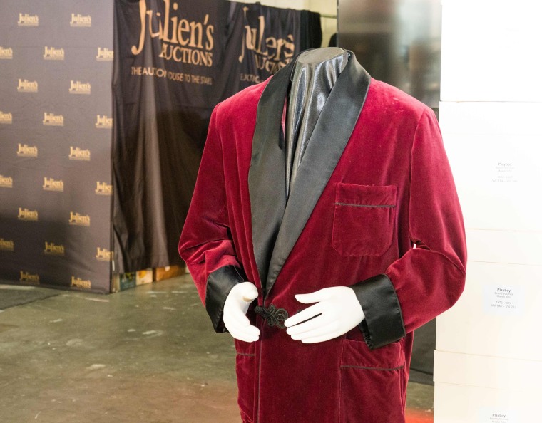 Image: Late Playboy publisher Hugh Hefner's scarlet silk damask smoking jacket with shawl collar is displayed as part of Julien's Auctions upcoming sale of his belongings