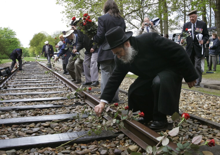 A rabbi places a rose on rail tracks near Westerbork, a former transit camp, on May 9, 2015.
