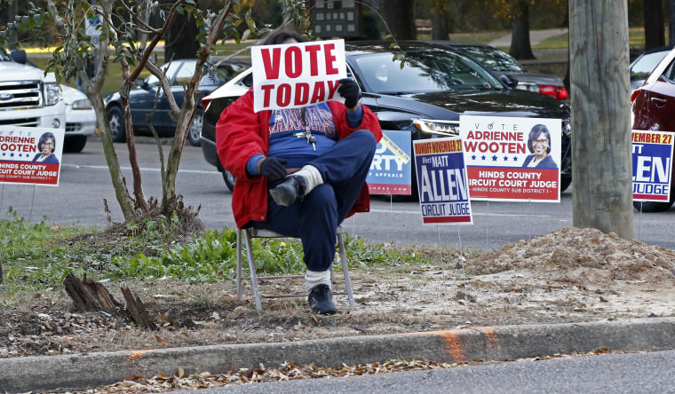 Image: A volunteer takes a seat at one of the busier intersections in north Jackson