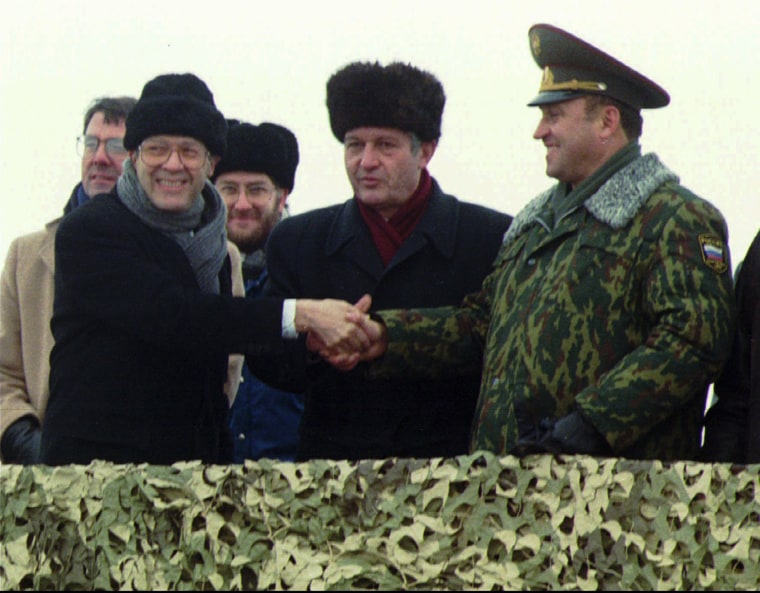 Image: Secretary of Defense William J. Perry, left, shakes hands with Ukraine Defense Minister Valery Shmarov, center, and Russian Defense Minister Pavel Grachev in 1996