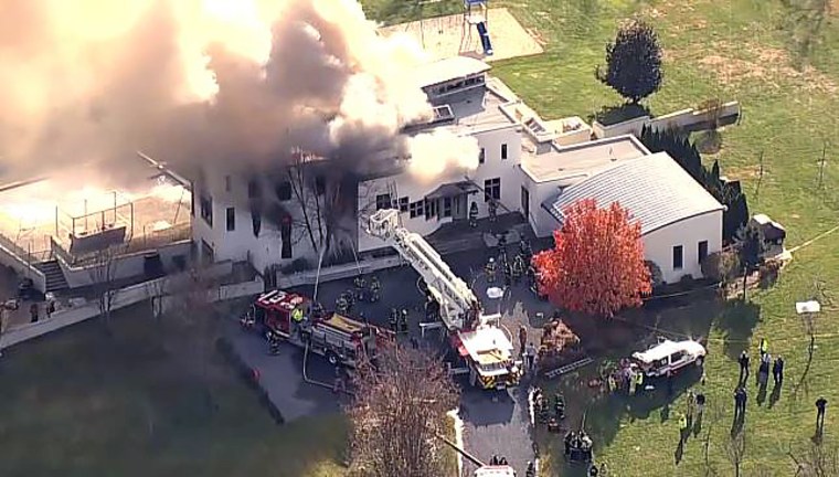 Firefighters at the scene of a fire in Colts Neck, New Jersey on Nov. 20, 2018