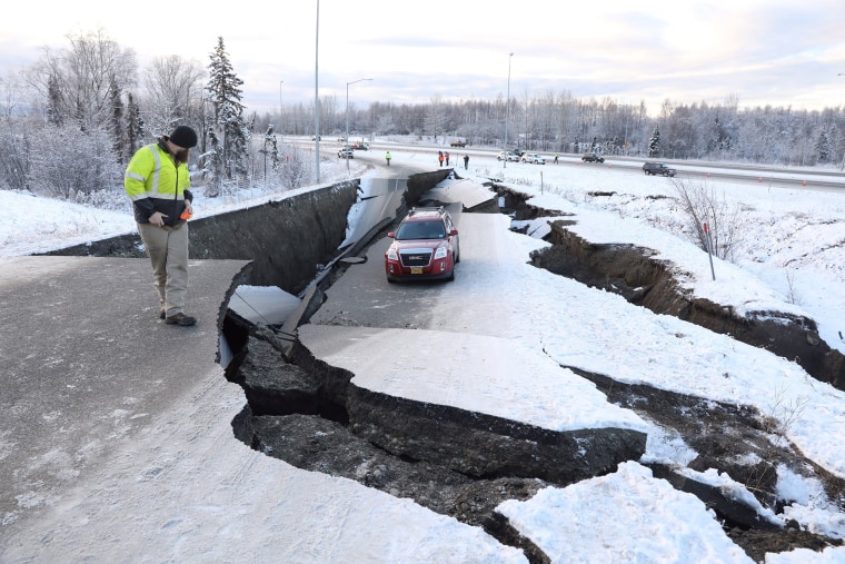 Image: A stranded vehicle lies on a collapsed roadway near the airport after an earthquake in Anchorage