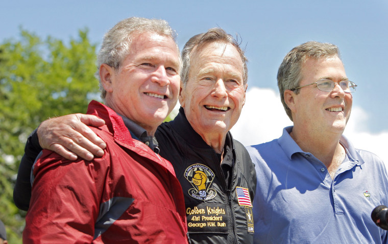 Image: George H. W. Bush poses with his sons, former President George W. Bush (left) and Jeb Bush