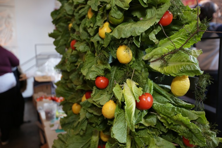The food sculptors used fresh lemons and tomatoes as ornaments on the leafy lettuce tree. 