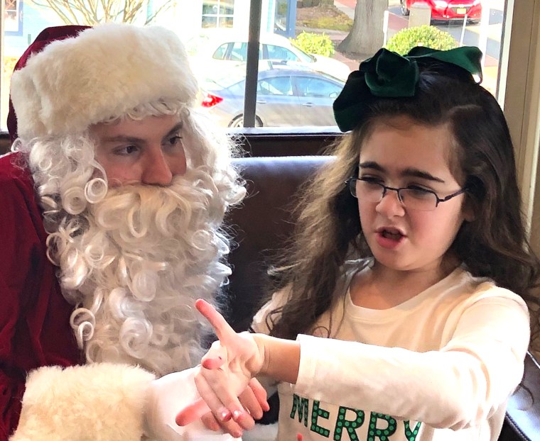 Sara Calligy, 10, who has autism, with Santa Kerry Magro, who also has autism