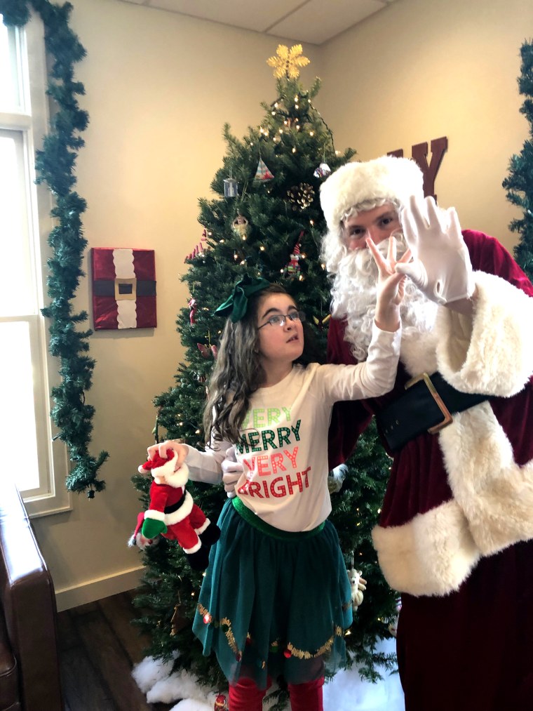 Sara Calligy, 10, who has autism, with Santa Kerry Magro, who also has autism.