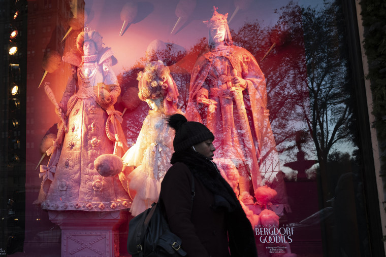 A woman passes a holiday window at Bergdorf Goodman, on Dec. 5, 2018, in New York.