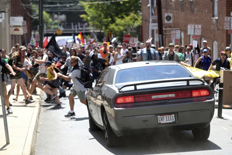 Image: A vehicle drives into a group of protesters demonstrating against a white nationalist rally in Charlottesville, Virginia, Aug. 12, 2017.