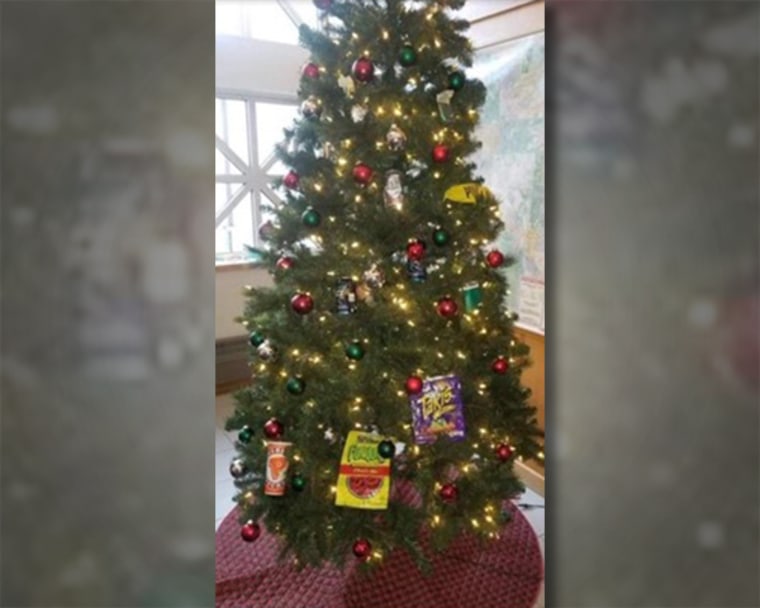 A photo on social media showed a holiday tree with empty beer and malt liquor cans, cigarette packs and bags of junk food like Funyons hanging off it.