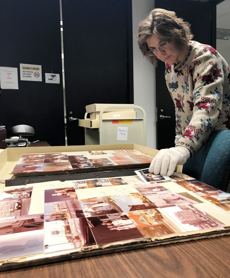 Archivist Mary Finch opens one of the 118 Bush family scrapbooks at the George H.W. Bush Presidential Library and Museum in College Station, Texas.