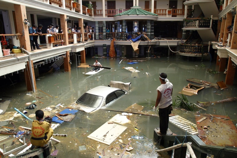 Rescue and clean-up crews survey a flooded lobby at the Seapearl Beach Hotel after a tsunami on Phuket Island, Thailand, on Dec. 28, 2004.