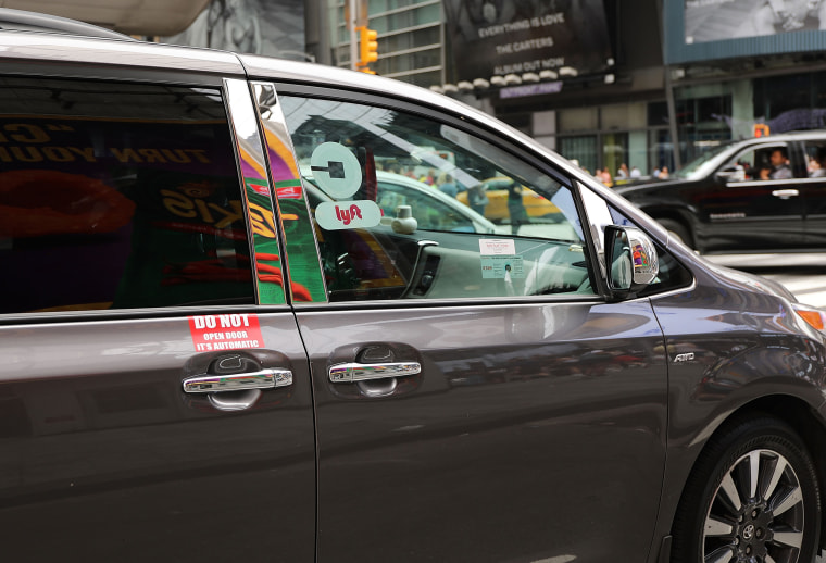 A Lyft ride hailing vehicle moves through traffic in New York