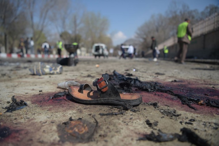 Image: A sandal lies on the ground after a suicide bombing near Kabul University 