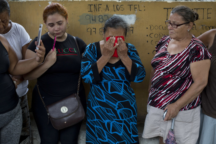 Image: Haydee Posadas wipes away tears during her son's burial at a cemetery in San Pedro Sula, Honduras on Oct. 31, 2018.