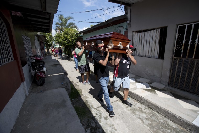 Image: Pallbearers carry Wilmer Gerado Nunez's casket in Ciudad Planeta, Honduras, on Oct. 31, 2018.
