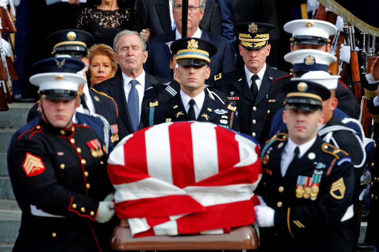 Image: Former U.S. President George W. Bush follows behind honor guard carrying casket of George H.W. Bush at Washington National Cathedral