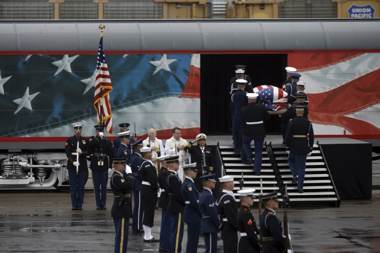 Image: A joint services military honor guard brings former President George H.W. Bush's casket onto a Union Pacific train.