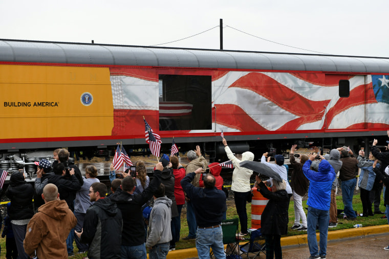 Image: Spectators cheer and wave flags as the train travels through Navasota, Texas.