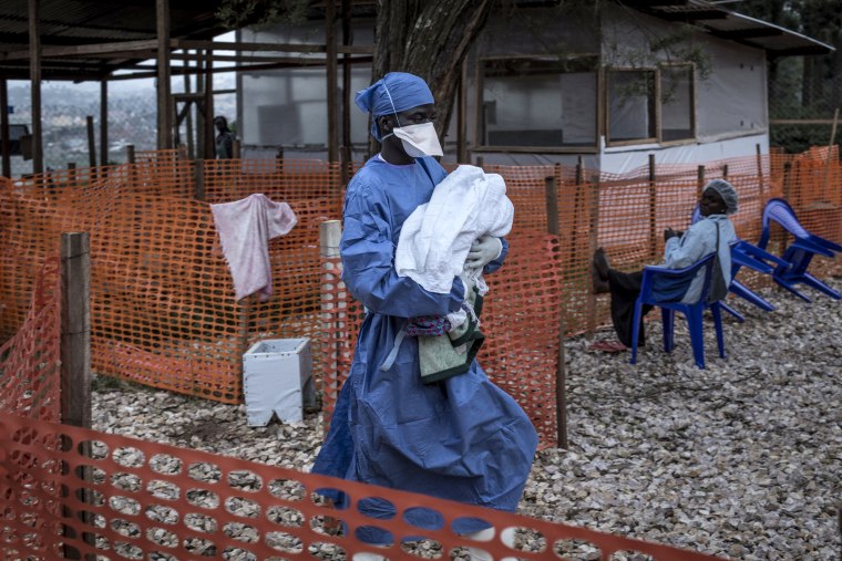 Image:A caretaker carries a baby suspected of having Ebola into a treatment center in Butembo, Congo, on Nov. 4, 2018.