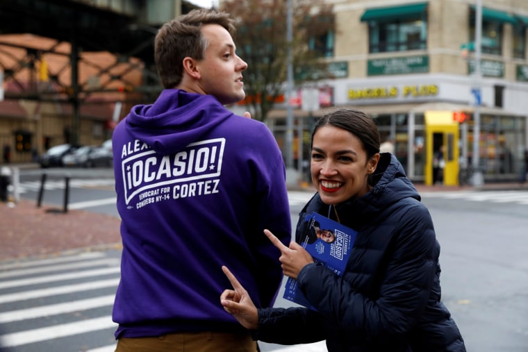 Image: Alexandria Ocasio-Cortez poses with a campaign worker 