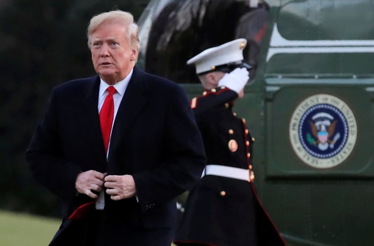 Image: President Donald Trump steps off Marine One and walks across the South Lawn after returning to the White House in Washington