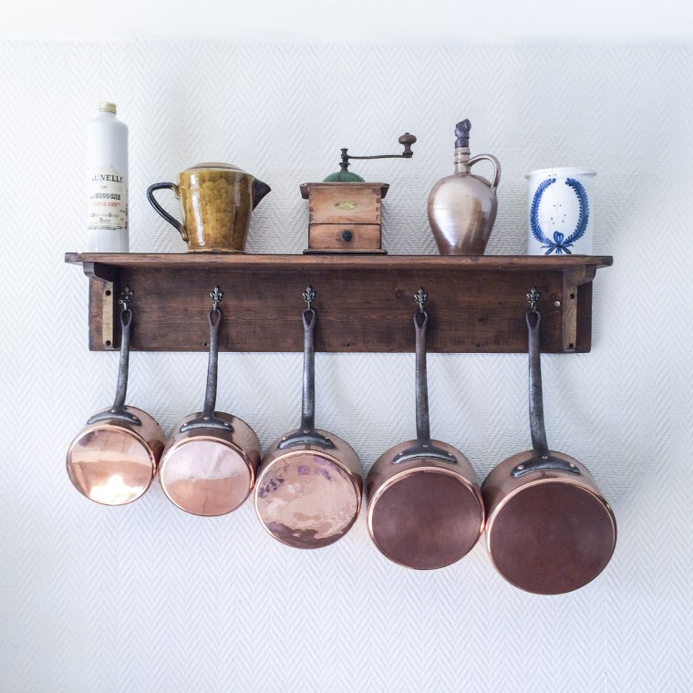 copper pots and pans hanging in kitchen