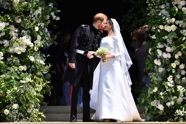 The new bride and groom kiss as they depart St. George's Chapel following their wedding ceremony.