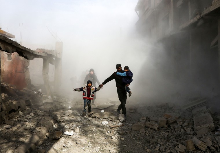 IMAGE: Syrian civilians flee air strikes