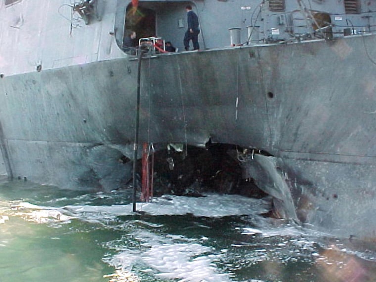 Image: The damaged port side of the guided missile destroyer USS Cole after an attack blamed on the al-Qaeda terror network