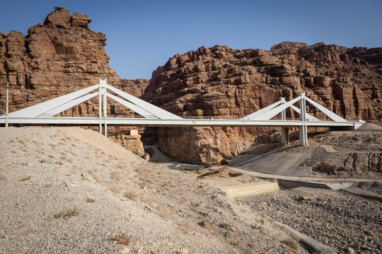 A bridge spans the dried-up Wadi Mujib riverbed.