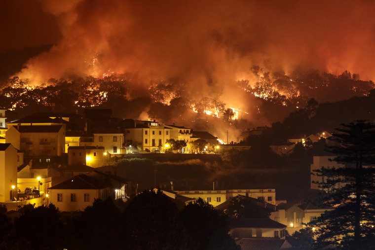 Image: A forest fire burns on a hill in Monchique, Portugal