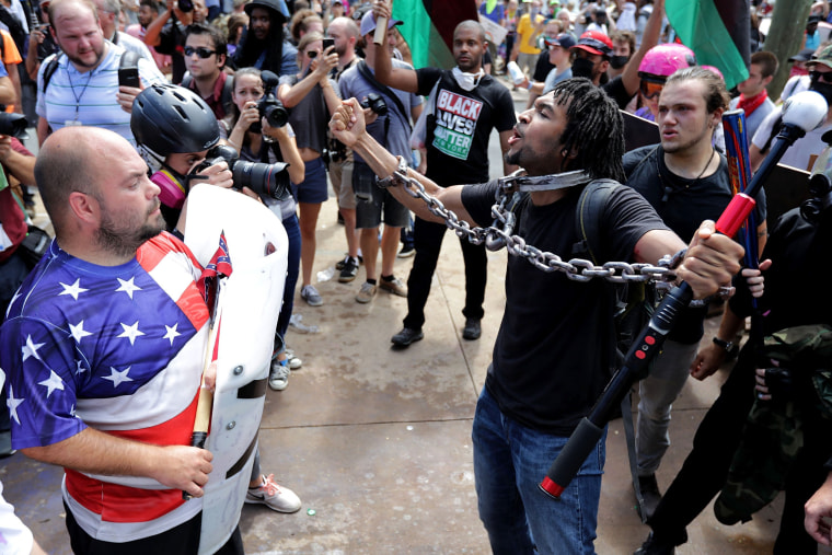 White nationalists, neo-Nazis and members of the "alt-right" exchange insuts with counter-protesters as they attempt to guard the entrance to Lee Park during the "Unite the Right" rally on Aug. 12, 2017 in Charlottesville, Virginia.