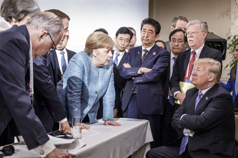 German Chancellor Angela Merkel speaks with U.S. President Donald Trump during the G-7 summit