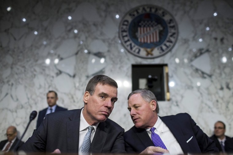 Senator Mark Warner, a Democrat from Virginia and ranking member of the Senate Intelligence Committee, left, and chairman Senator Richard Burr, a Republican from North Carolina, speak before the start of a hearing in Washington, on Feb. 13, 2018.