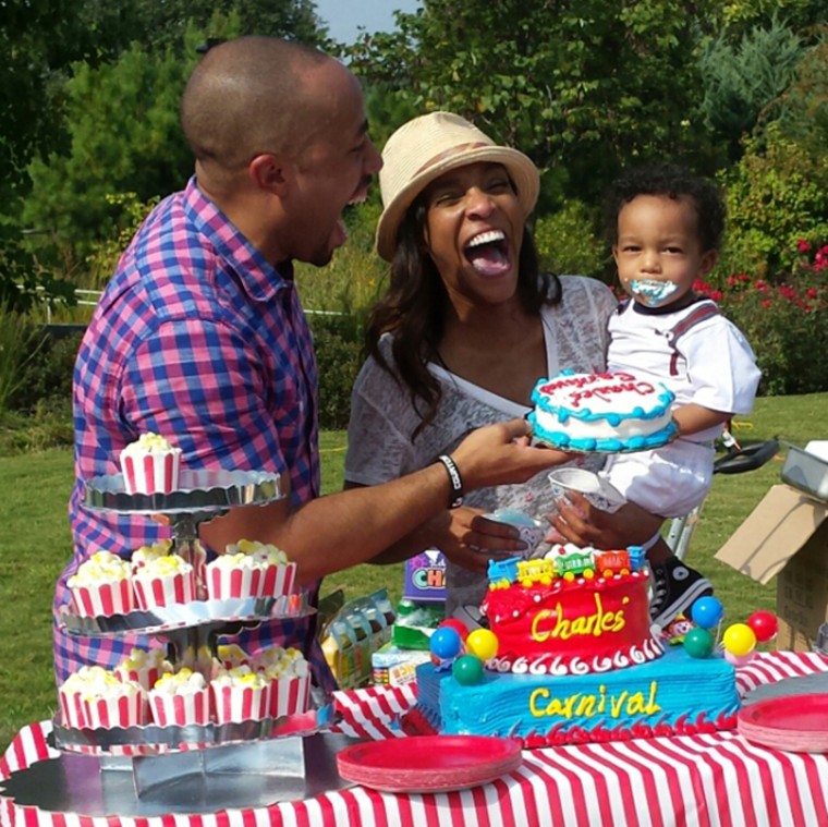 Image: Kira Johnson and her husband, Charles Johnson IV, laugh with their son Charles Johnson V at his birthday party.