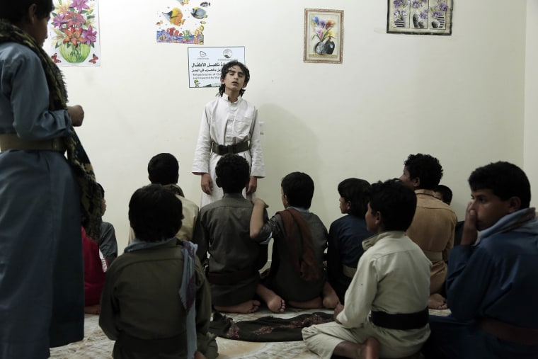 Image: Boys recite poems during a session at a rehabilitation center for former child soldiers in Marib