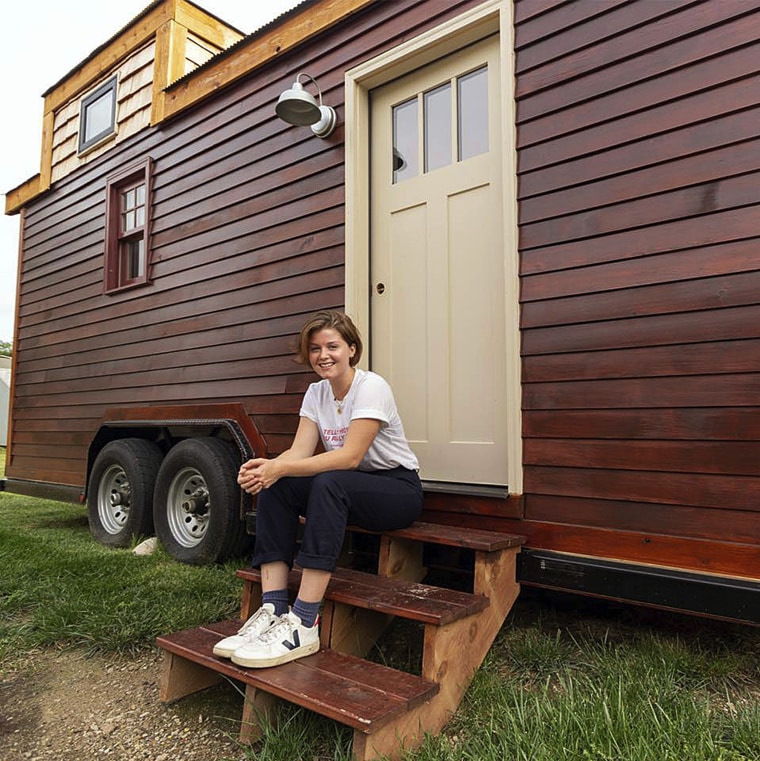 Image: Meghan Panu sits on the front steps of her house in St. Louis. The 12-foot-tall house was hitched to a pickup truck and stolen, and was later found by police.