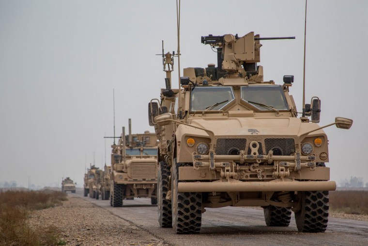 A convoy of military vehicles in the anti-ISIS coalition travels in Syria's Deir ez-Zor province on Nov.  22.