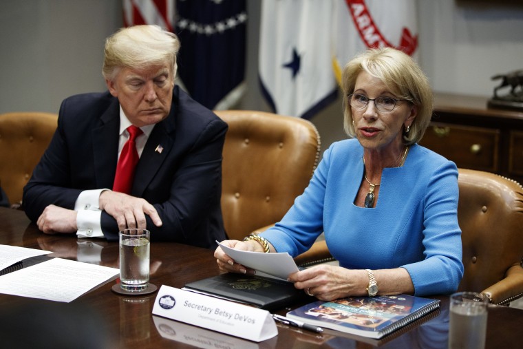 President Donald Trump listens as Secretary of Education Betsy DeVos speaks discusses the Federal Commission on School Safety report