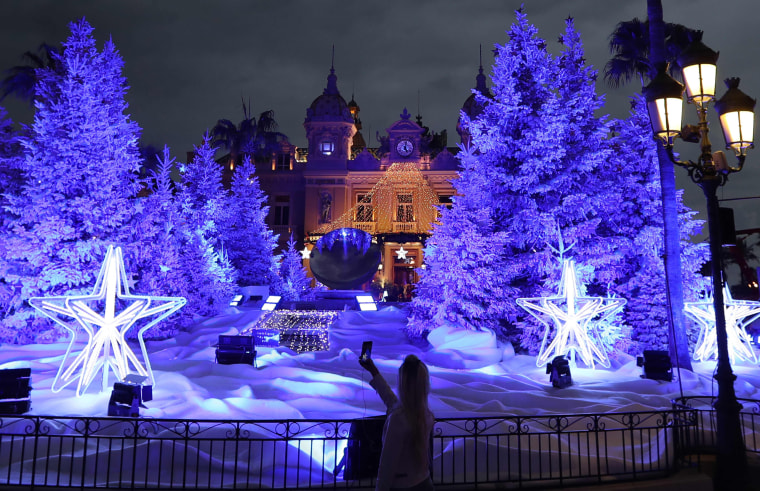 Image: People visit the Christmas lights and decoration display in front of the Monte-Carlo Casino