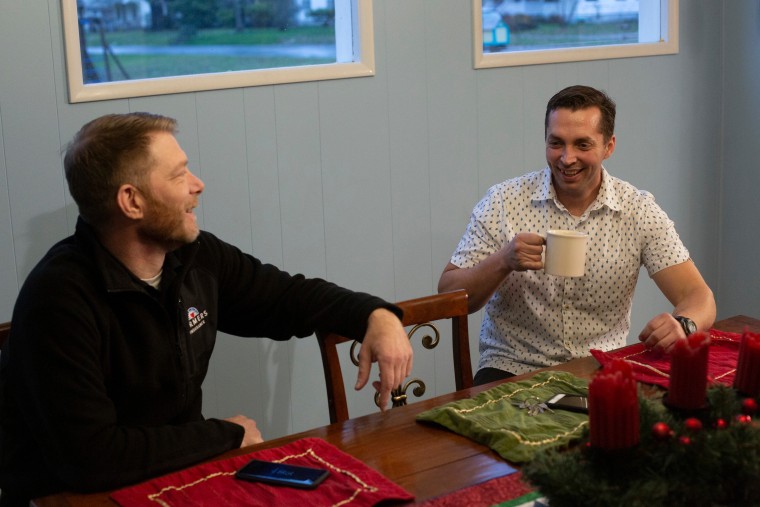 Vince Villano, left, and Justin McNeil share a laugh at the McNeil home on Dec.11. (Photo by David Ryder)