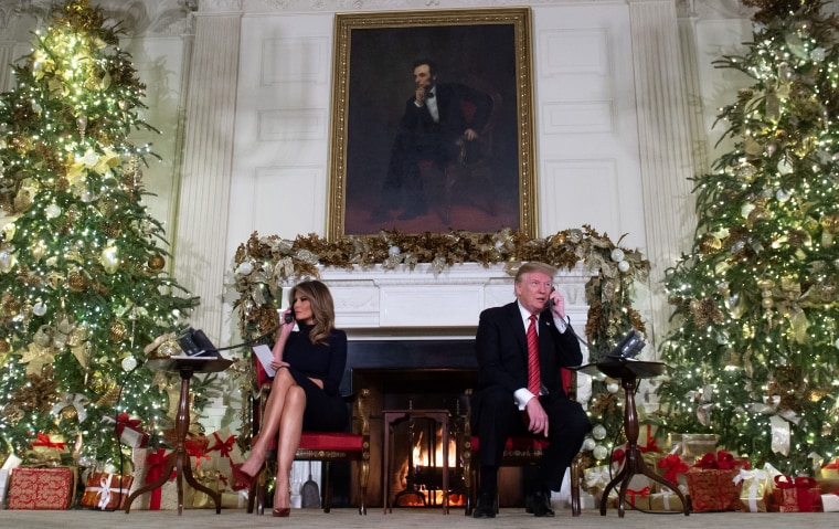 Image: President Donald Trump and Melania Trump answer calls from children calling into the NORAD Santa tracker at the White House on Dec. 24.
